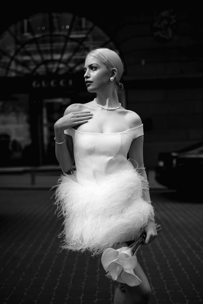 White bridal off-shoulder mini dress with structured satin bodice & soft voluminous feather skirt, short wedding gown